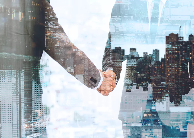 Business handshake with city background